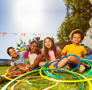 Children sitting with hula hoops