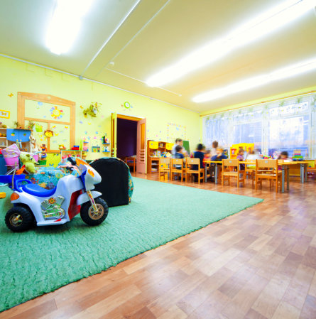 A classroom with children and some toys